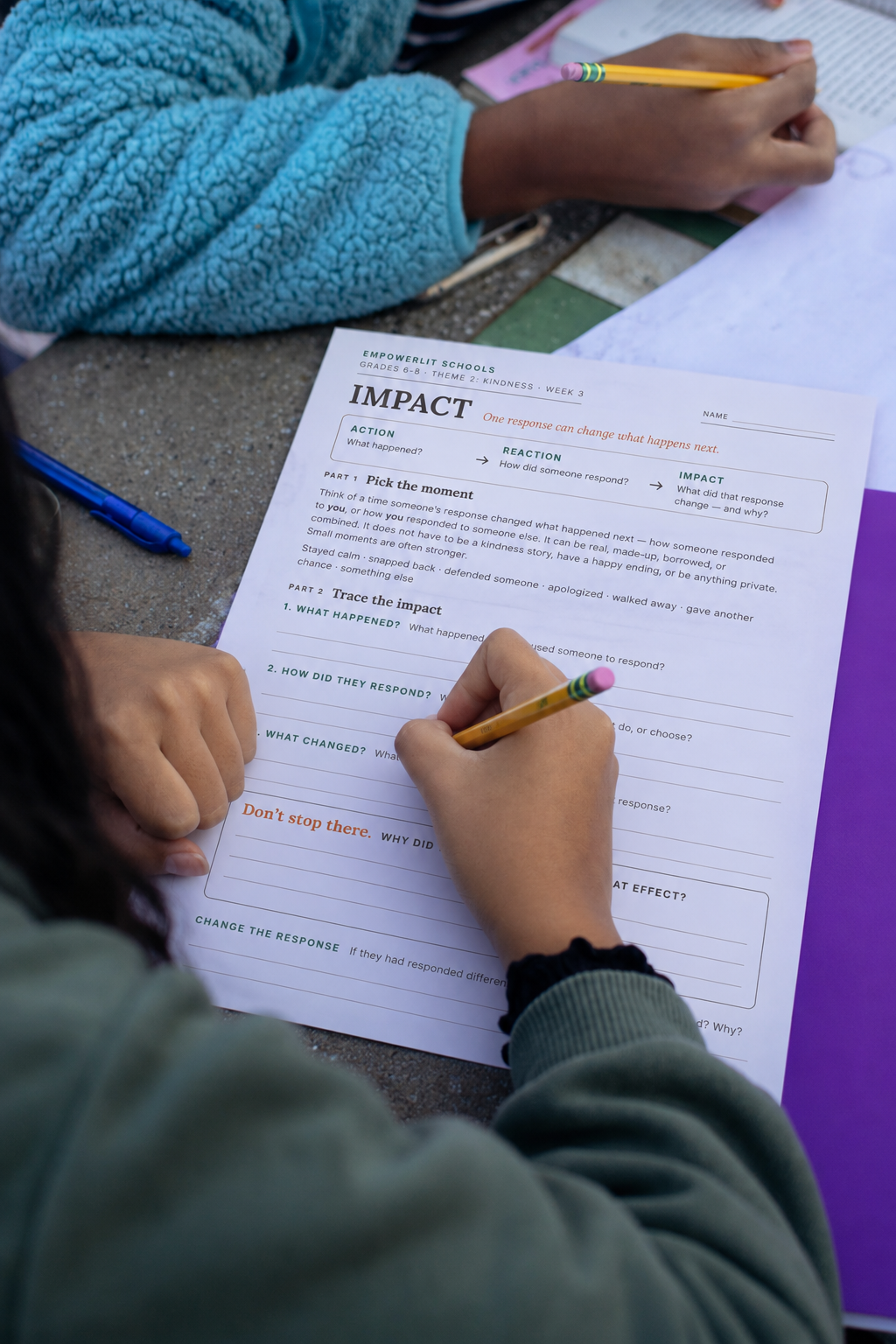Middle school students working with an EmpowerLit handout